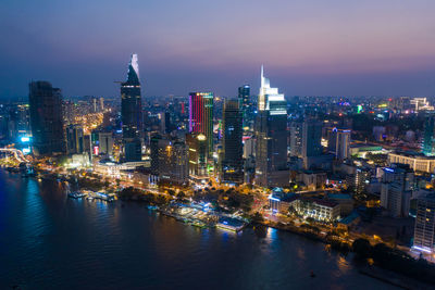 Illuminated buildings against sky at night