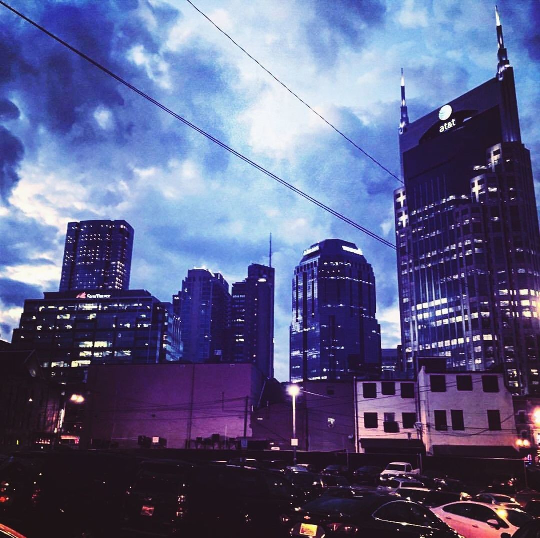 LOW ANGLE VIEW OF MODERN BUILDINGS AT NIGHT