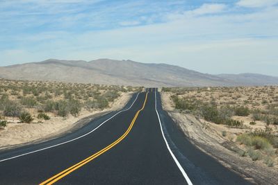 Country road leading towards mountains