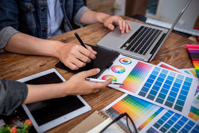 High angle view of people working on table