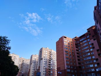 Low angle view of buildings against blue sky