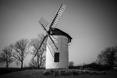 Low angle view of old windmill against clear sky