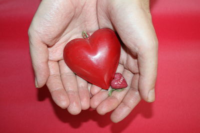 Close-up of woman holding red heart