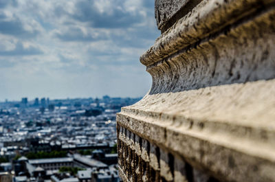 Close-up of historical building against cloudy sky