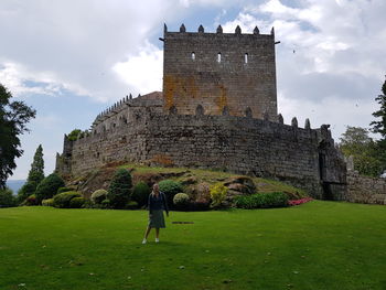 Man by historic building against sky