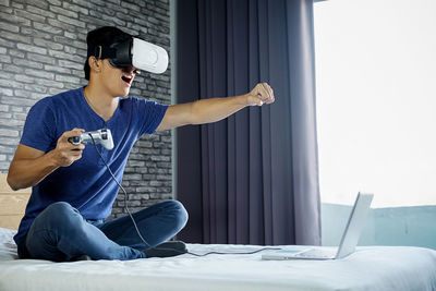 Man using virtual reality at home