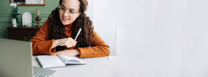 Young woman using laptop at home