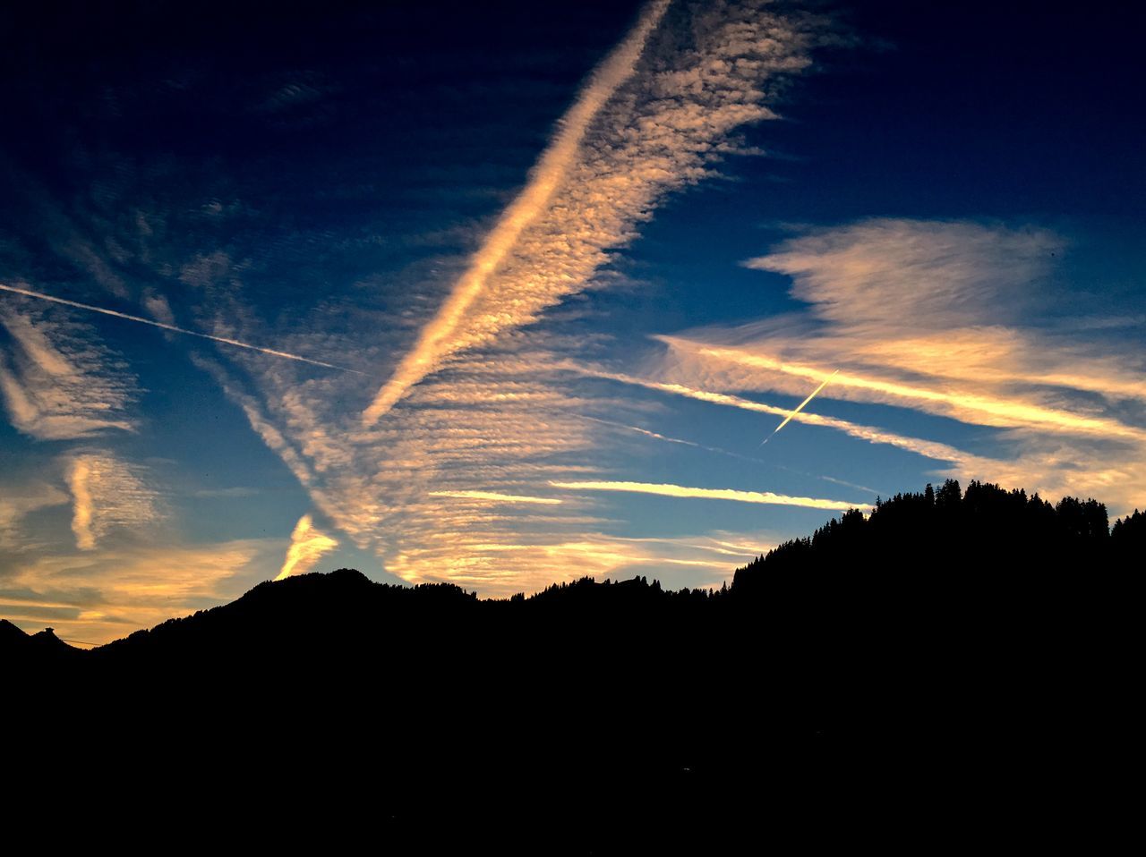 silhouette, scenics, tranquil scene, beauty in nature, sunset, tranquility, sky, nature, mountain, landscape, idyllic, blue, vapor trail, tree, majestic, cloud - sky, cloud, dusk, non-urban scene, outdoors