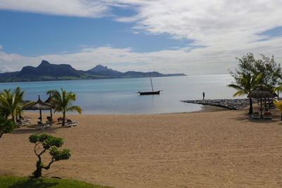 View of beach against cloudy sky