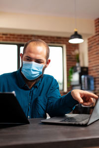 Young man using laptop at office