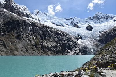 Scenic view of lake against mountains during winter