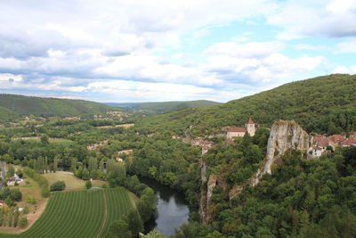 Scenic view of trees and buildings against sky