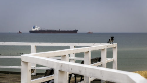 Pier on sea against clear sky