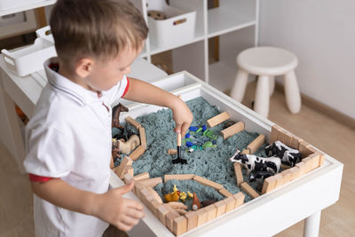 High angle view of boy playing with toys