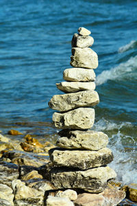 Stacked rocks against sea