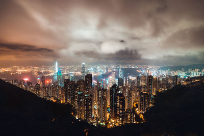 Illuminated cityscape against sky at night