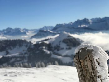 Close-up of snow on mountain against sky