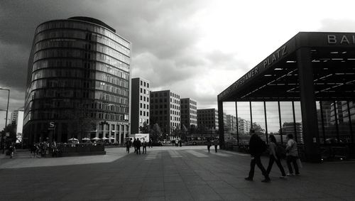 Buildings in city against cloudy sky