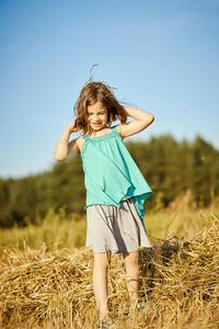 Full length of girl standing on field