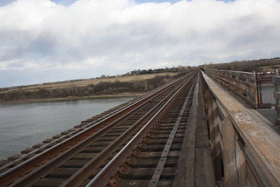 View of railroad tracks against cloudy sky