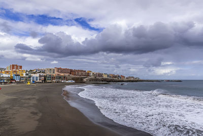 Panoramic view of beach and buildings against sky