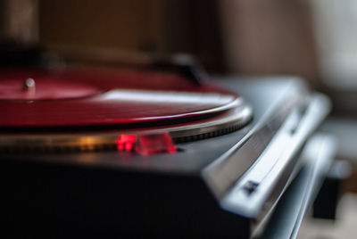 Close-up of red record playing in turntable