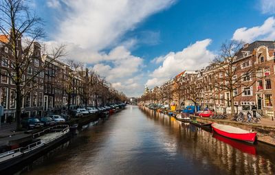 Boats moored on canal in city