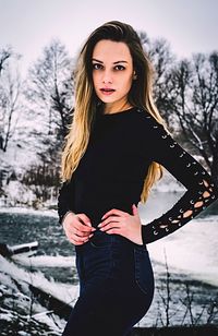 Portrait of woman standing in snow