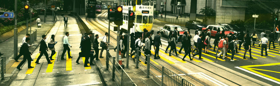 Side view of people crossing road