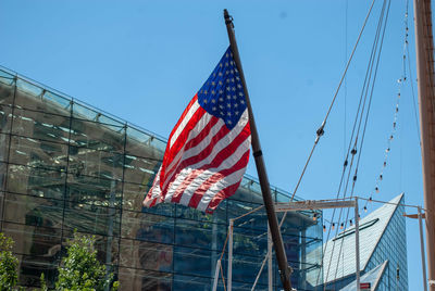 Low angle view of american flag against sky