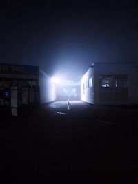 Man walking on illuminated street at night