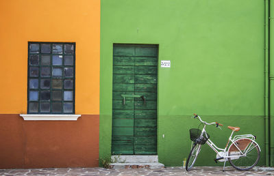 Bicycle against wall in city