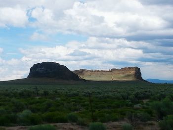 Scenic view of landscape against cloudy sky