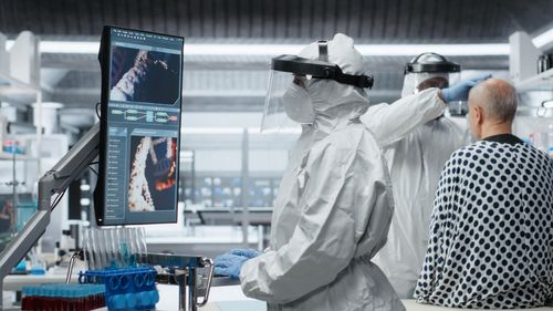 Rear view of man working in laboratory