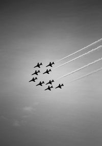 Low angle view of airplane flying against sky