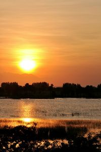 Scenic view of lake at sunset