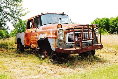 Abandoned car on field