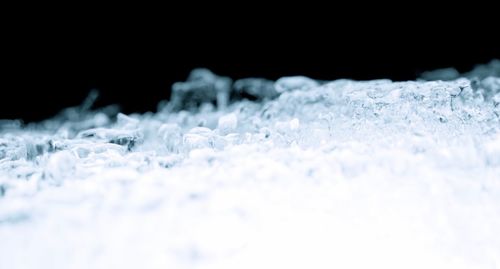 Close-up of snow on black background