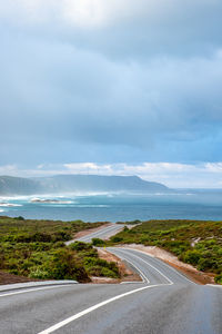 Road by sea against sky