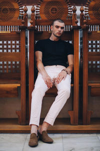 Portrait of young man sitting on seat