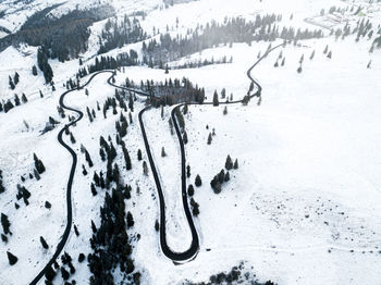 Aerial view of road on snow covered land during winter