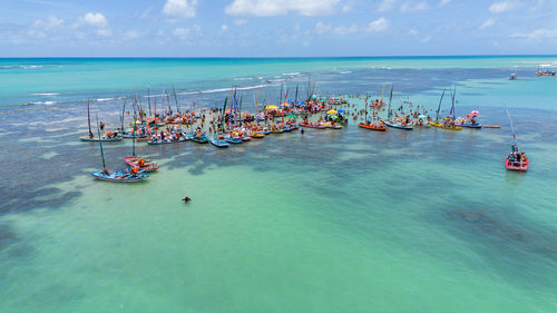 High angle view of people at beach against sky