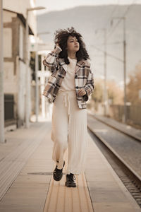 Portrait of young woman standing in city