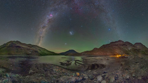 Scenic view of mountains against sky at night