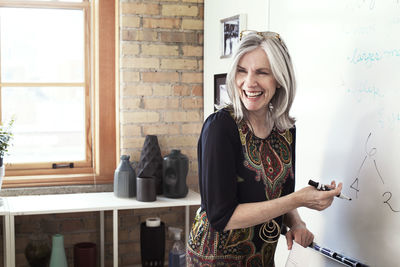 Happy businesswoman giving presentation in creative office