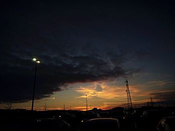 Cars on road against sky at night