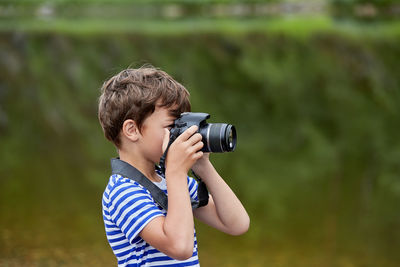 Full length of boy photographing