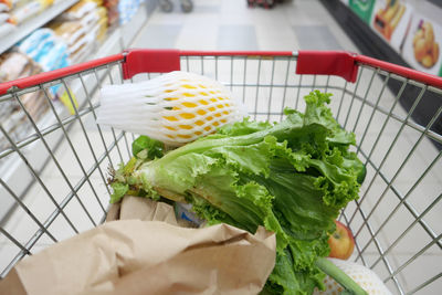 Fresh vegetables and fruits in a shopping trolly at store