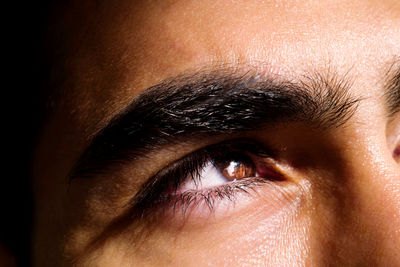 Close up portrait of the eye of a man looking away