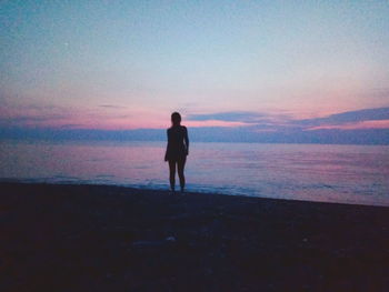 Silhouette of man standing on beach